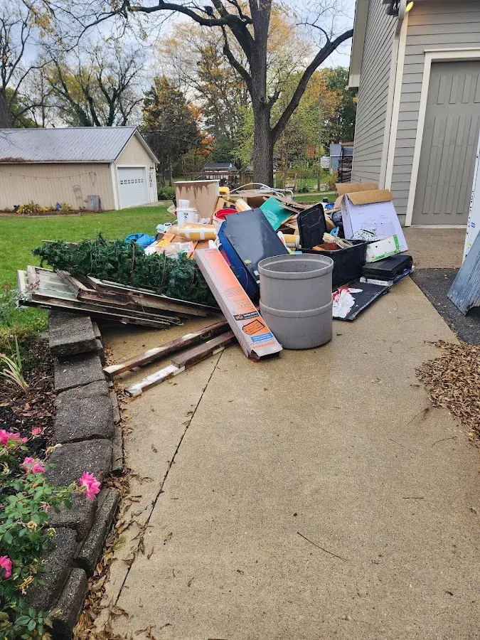 Dumpster being loaded with debris for Estate Cleanout Dumpster Rental in Fenton